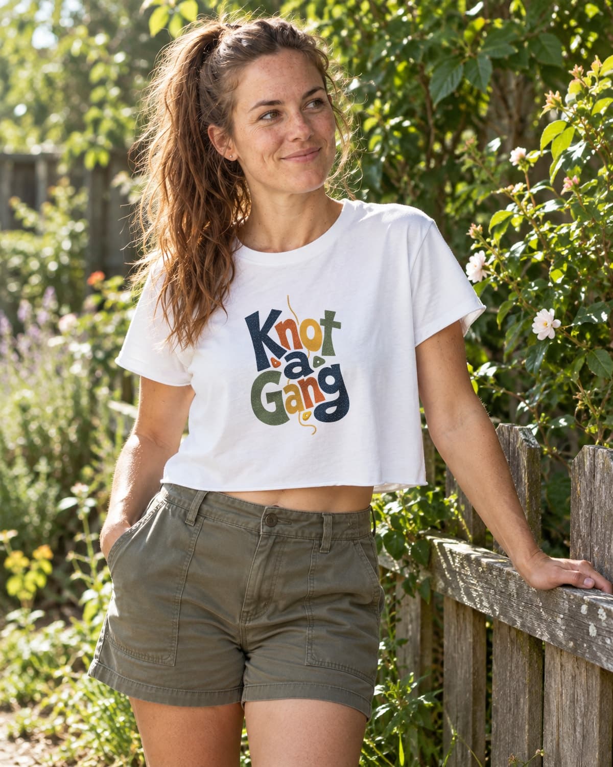A woman wearing the White Type Can Lean crop top in a relaxed lifestyle setting.