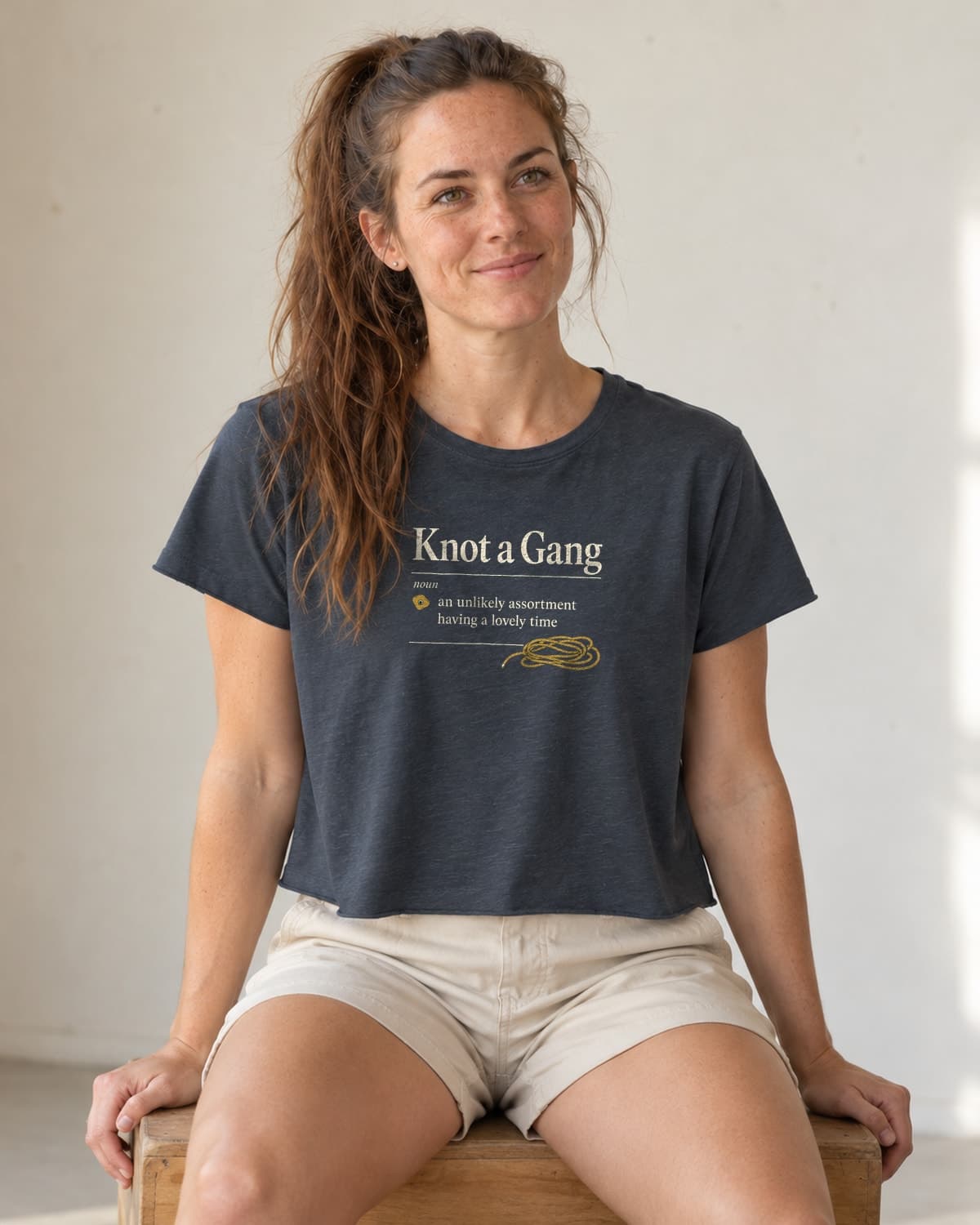 A woman wearing the Antique Denim A Collective Noun crop top in natural studio light.