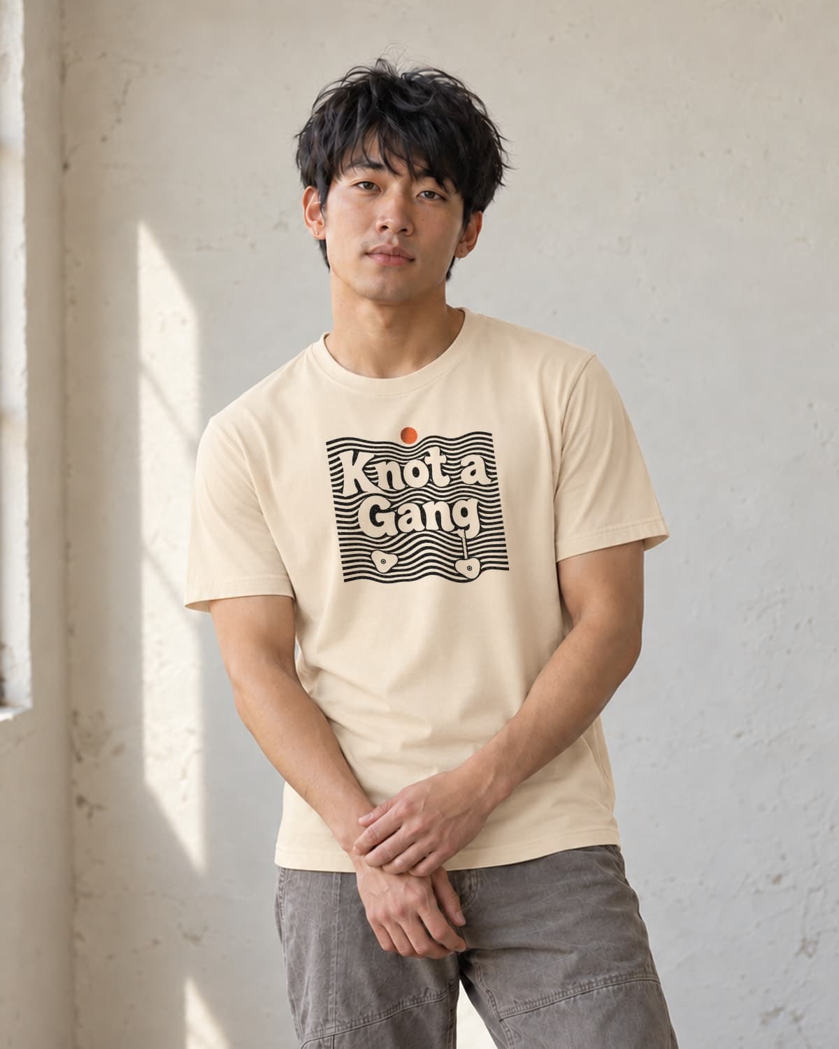 A man wearing the Cream Double Take T-shirt in natural studio light.