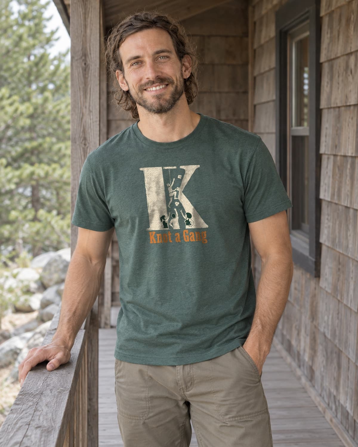 A man wearing the Heather Forest Green The Big K T-shirt in a relaxed lifestyle setting.