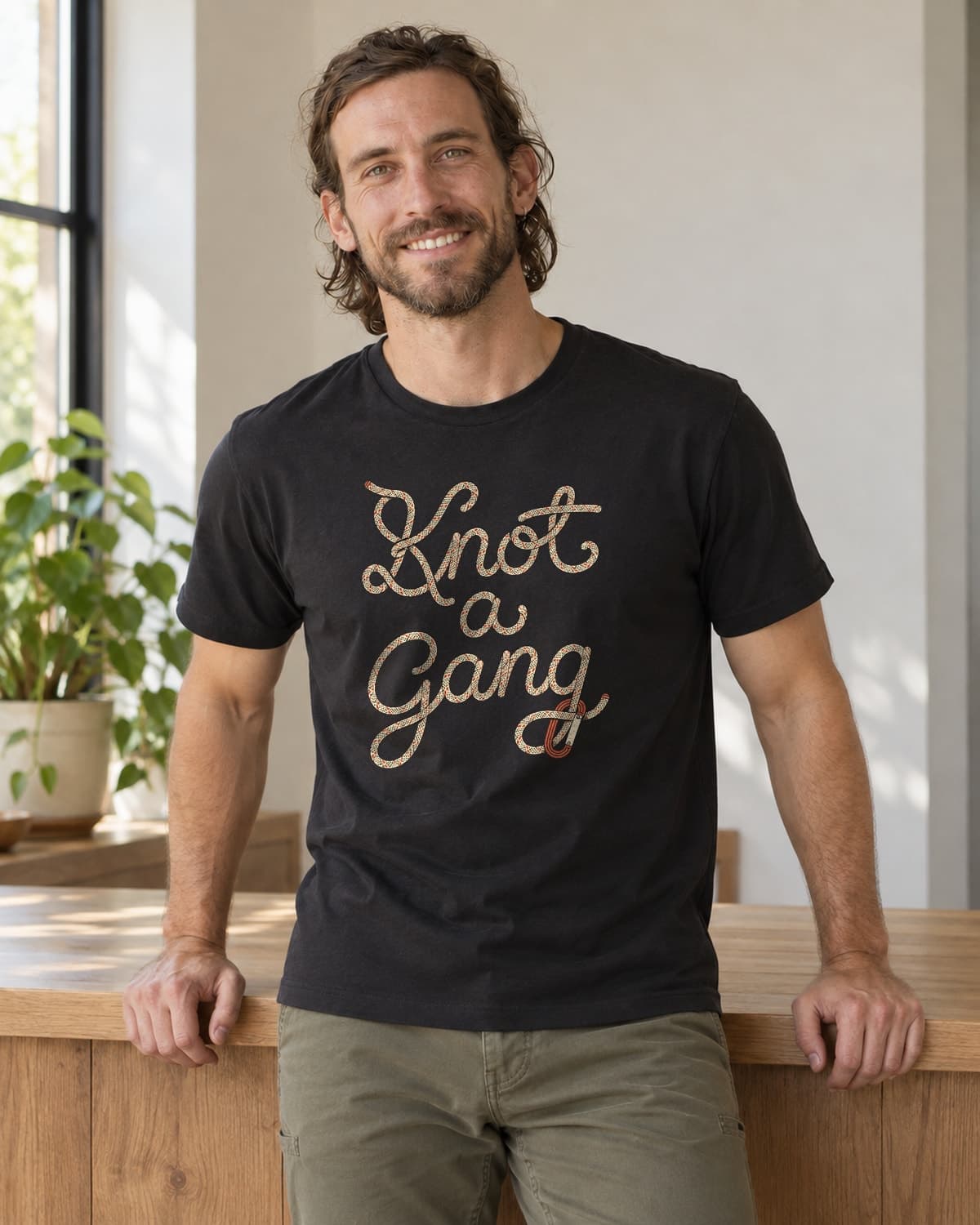 A man wearing the Black Braided Script and a Clip T-shirt in natural studio light.