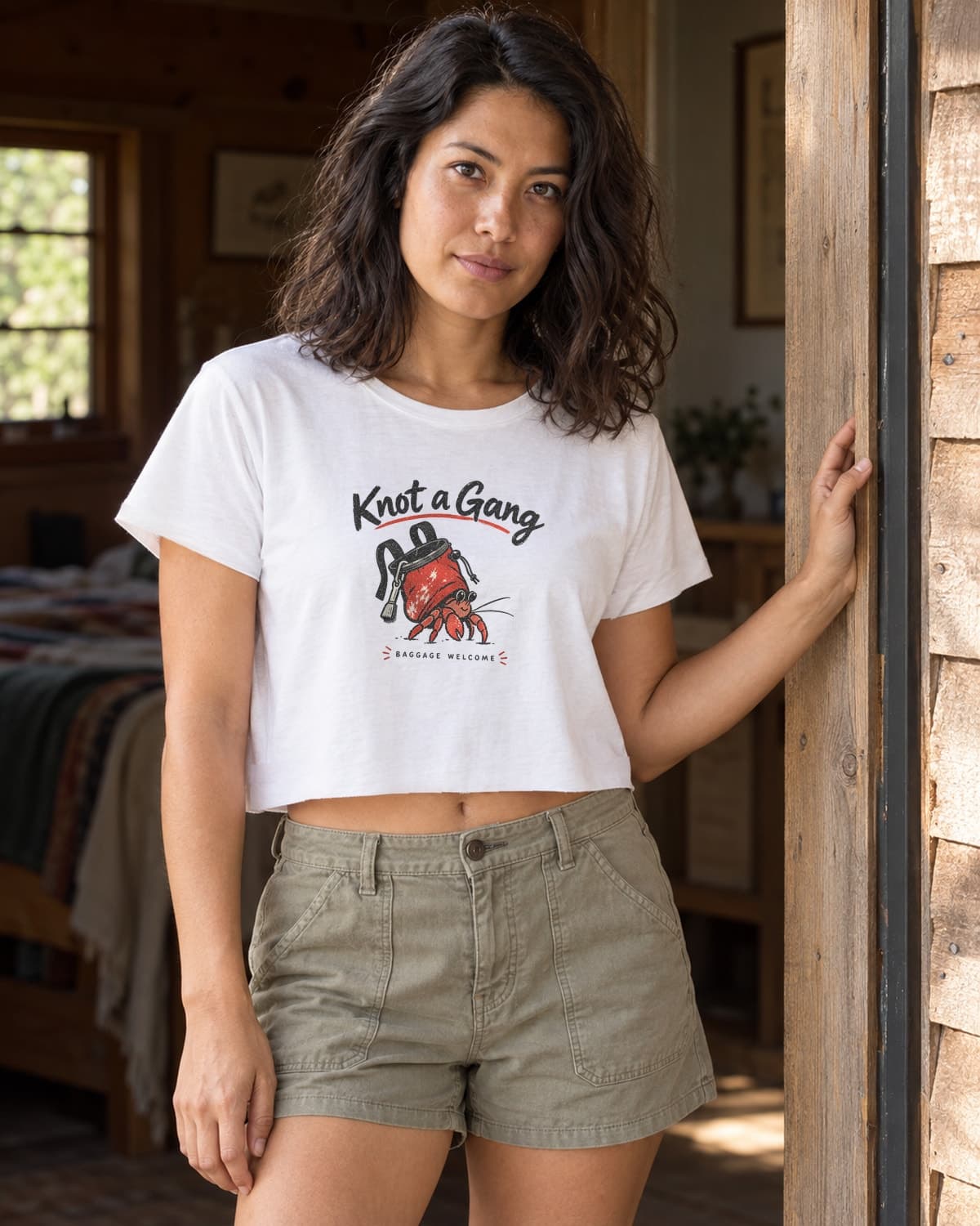 A woman wearing the White Baggage Welcome crop top in a relaxed lifestyle setting.