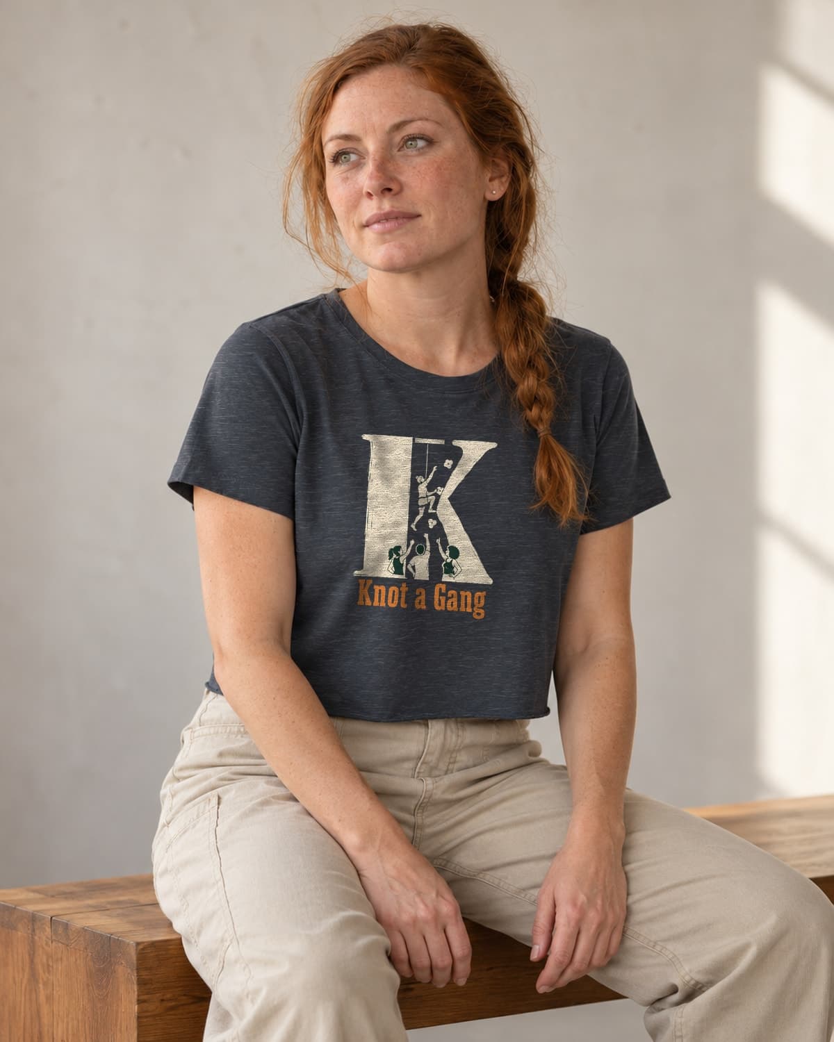 A woman wearing the Antique Denim The Big K crop top in natural studio light.