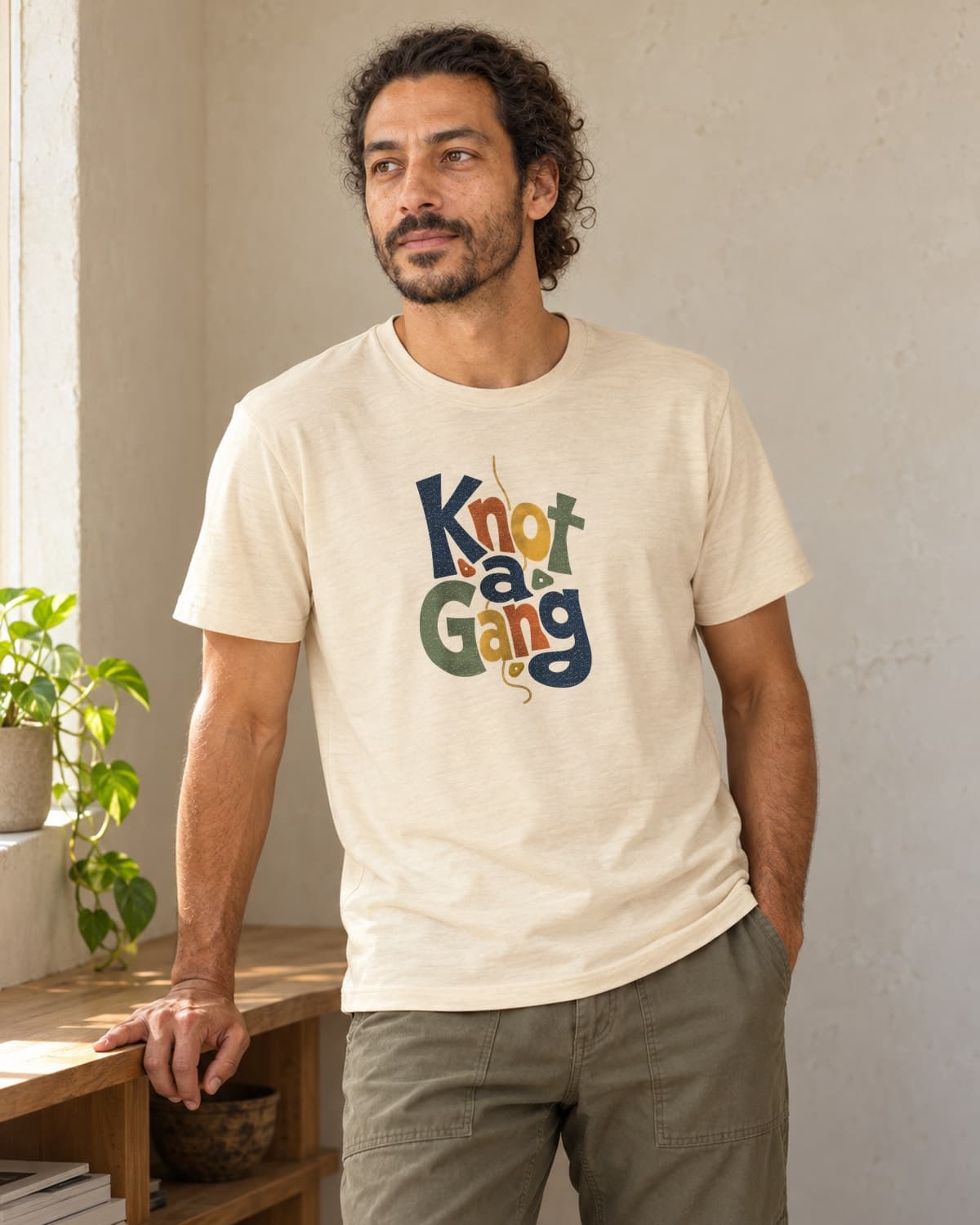 A man wearing the Cream Type Can Lean T-shirt in natural studio light.
