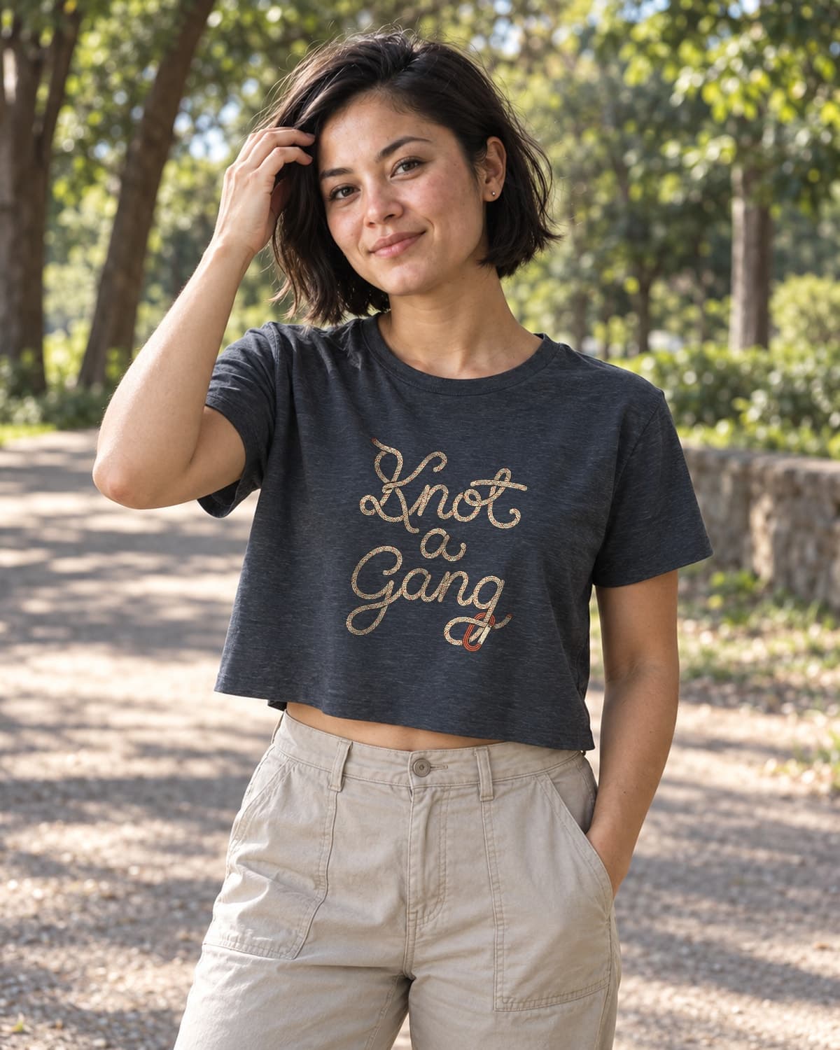 A woman wearing the Antique Denim Braided Script and a Clip crop top in a relaxed lifestyle setting.