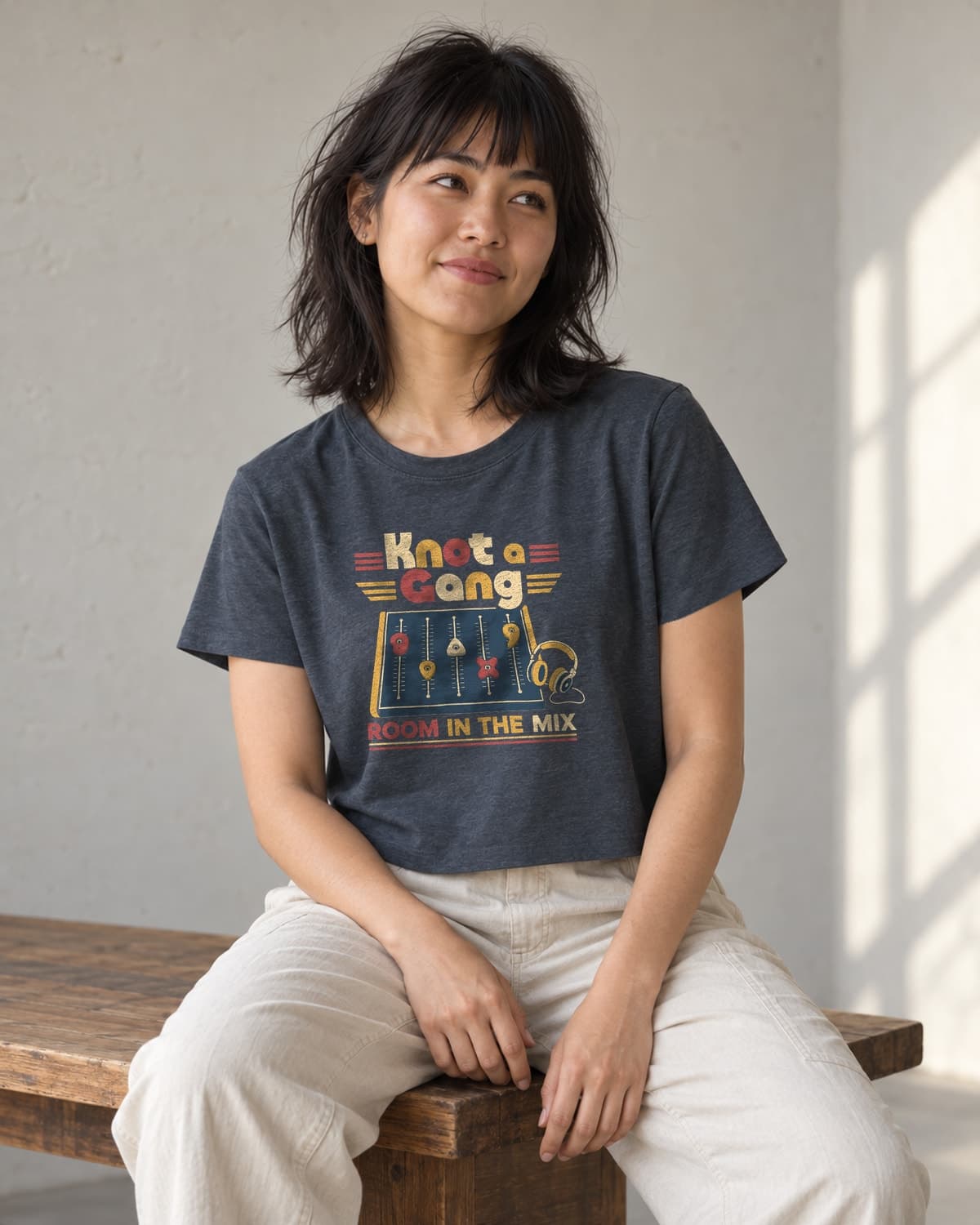 A woman wearing the Antique Denim Room In The Mix crop top in natural studio light.
