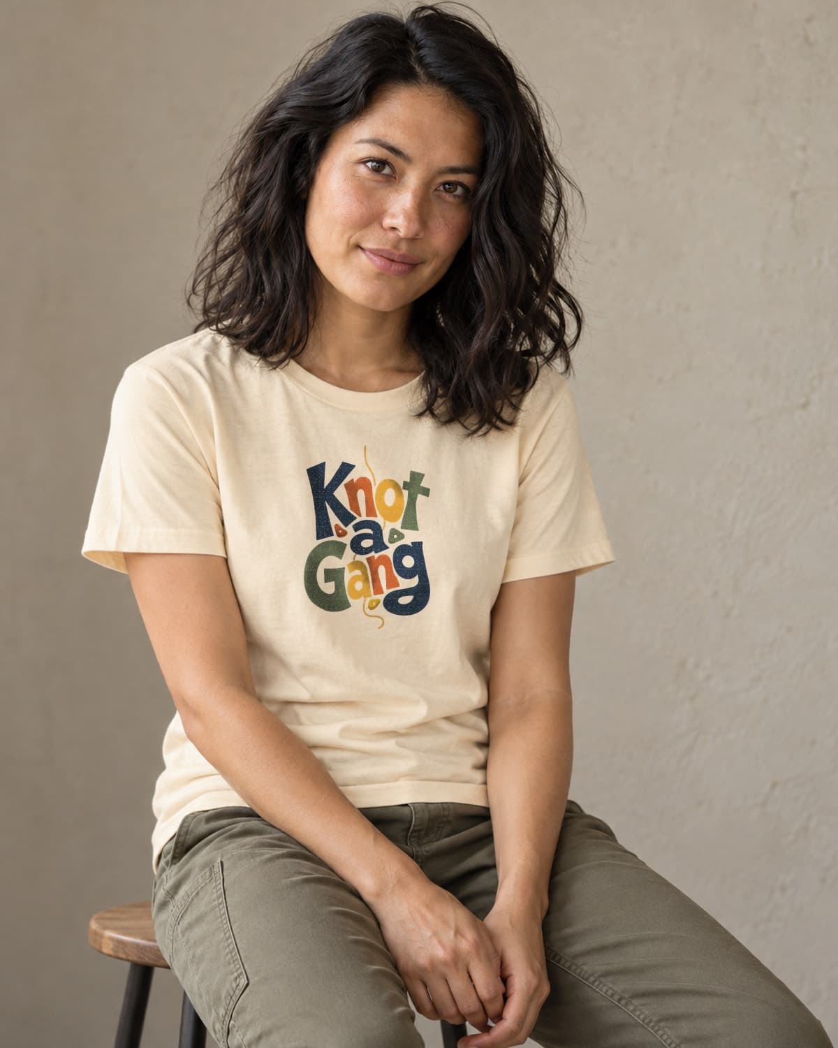A woman wearing the Cream Type Can Lean T-shirt in natural studio light.