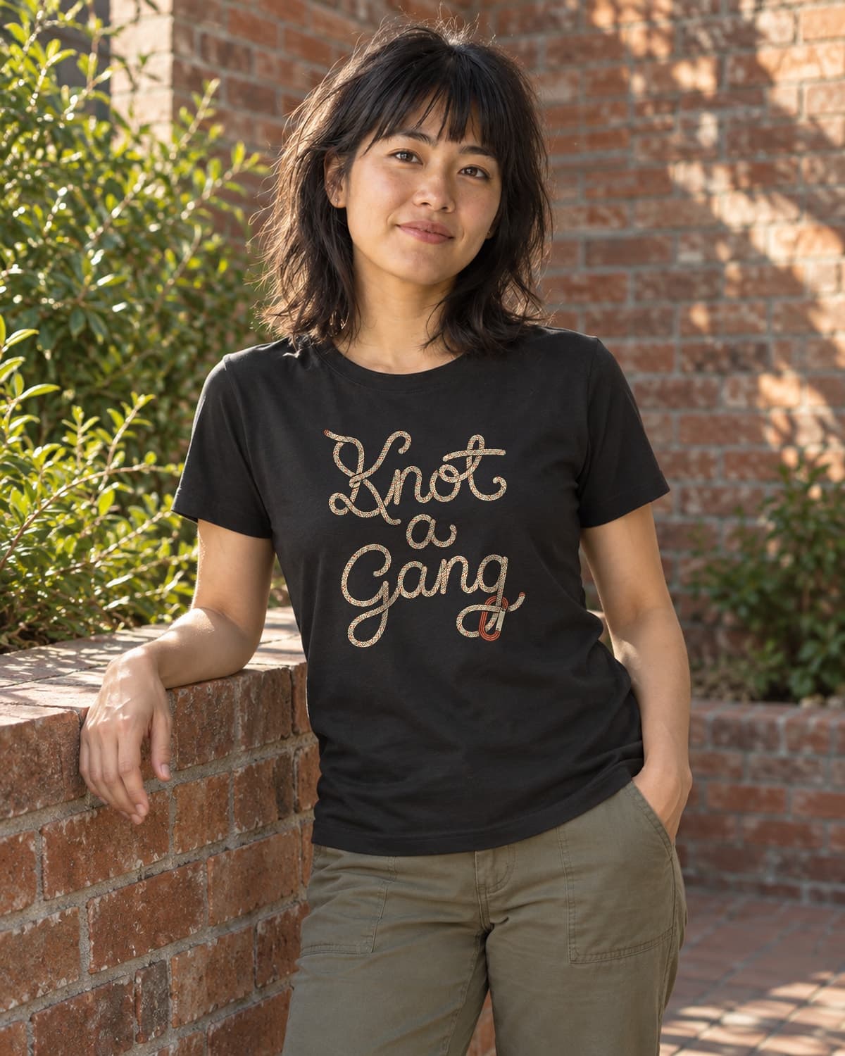 A woman wearing the Black Braided Script and a Clip T-shirt in a relaxed lifestyle setting.