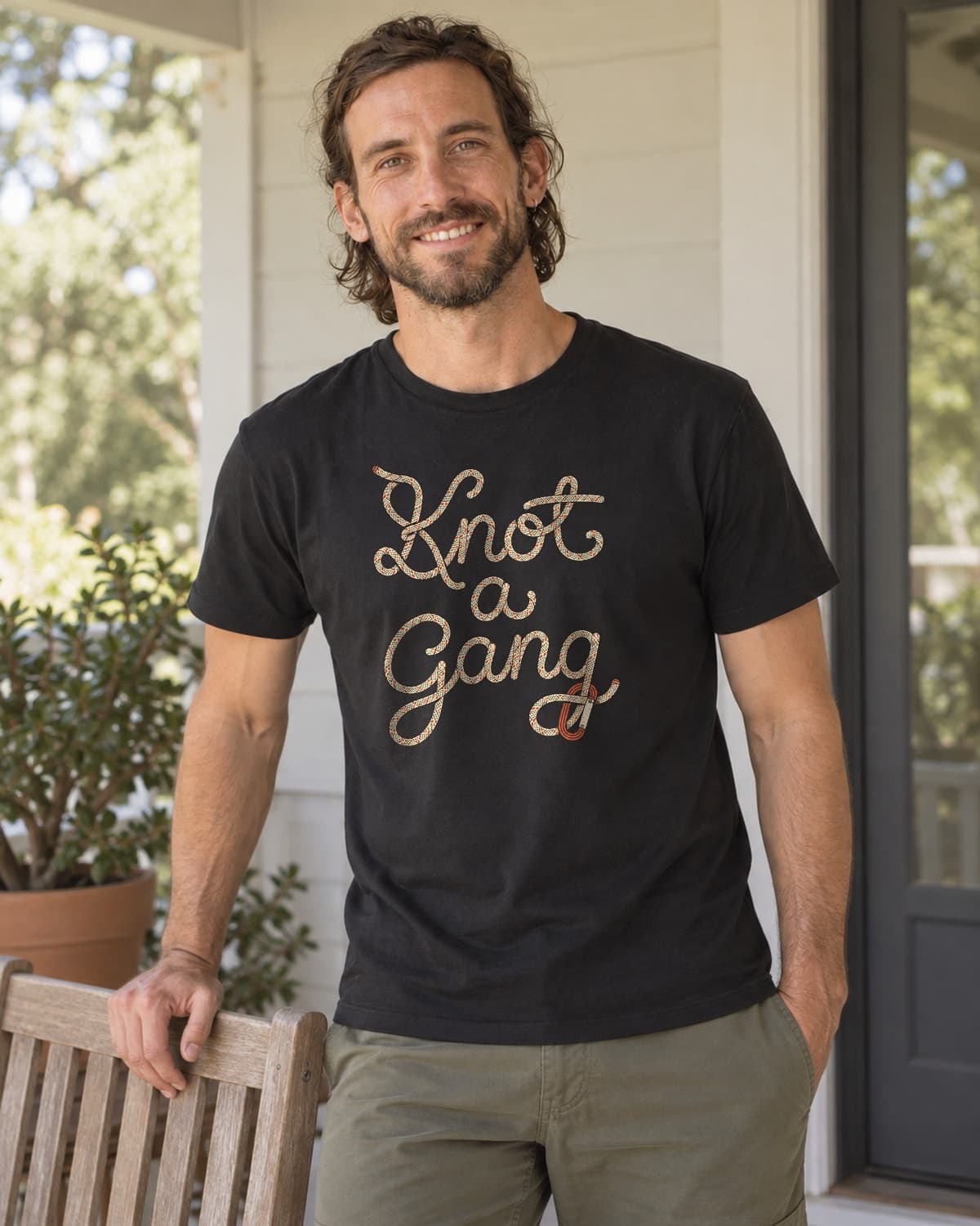 A man wearing the Black Braided Script and a Clip T-shirt in a relaxed lifestyle setting.