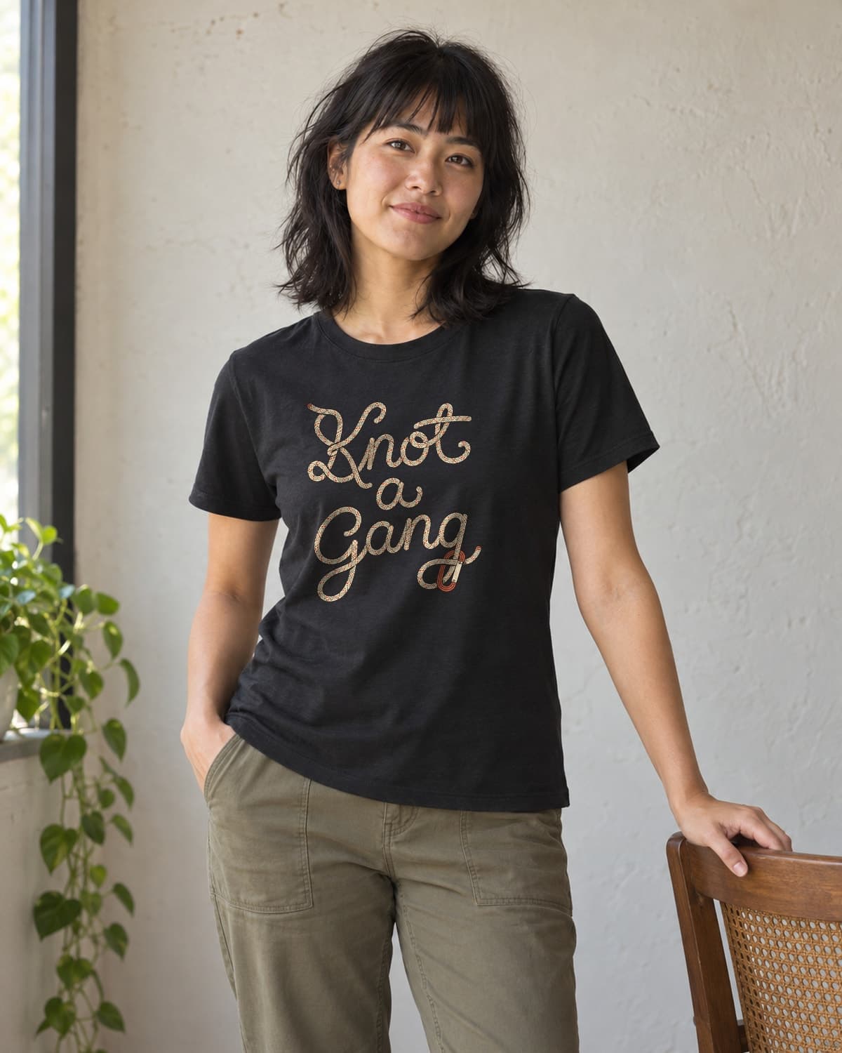 A woman wearing the Black Braided Script and a Clip T-shirt in natural studio light.
