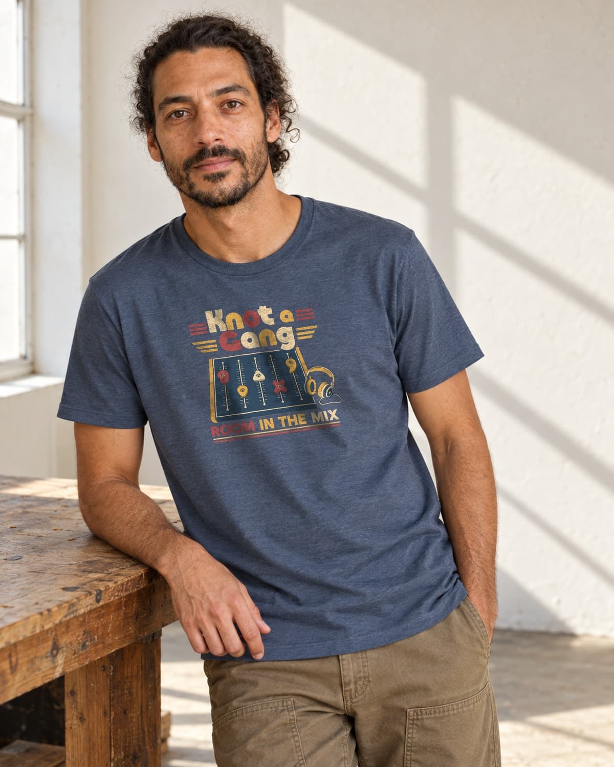 A man wearing the Indigo Room In The Mix T-shirt in natural studio light.
